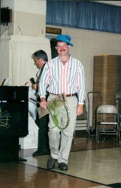 Chief John Chambers picks up his gag gifts at the 1998 Parade Party.  Can anybody explain this photo?
